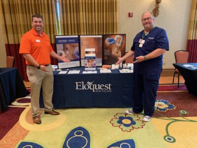 Eloquest team members at conference booth.