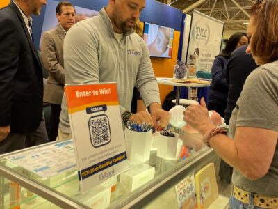 Trade show. Eloquest Healthcare team member at trade show